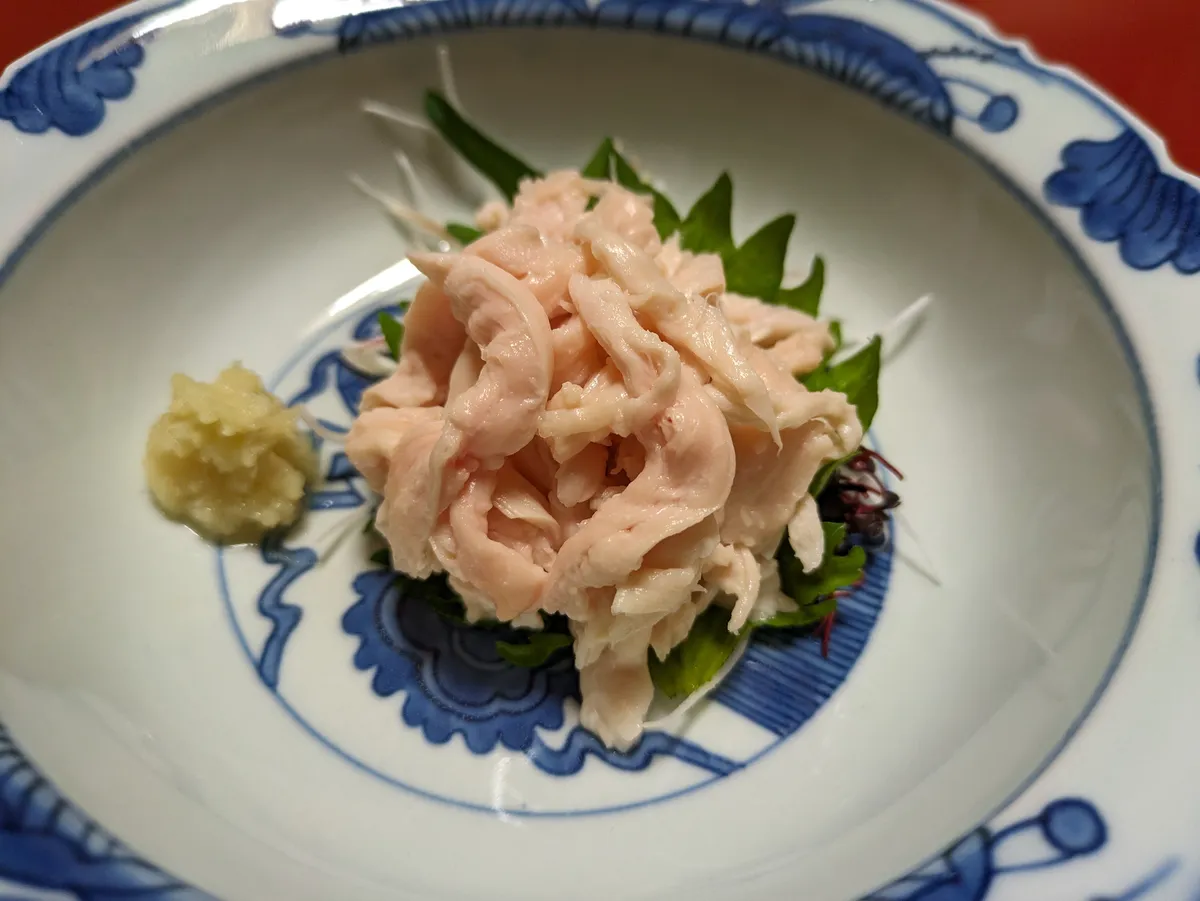 Nagoya Cochin chicken sashimi served with shiso leaf and grated ginger