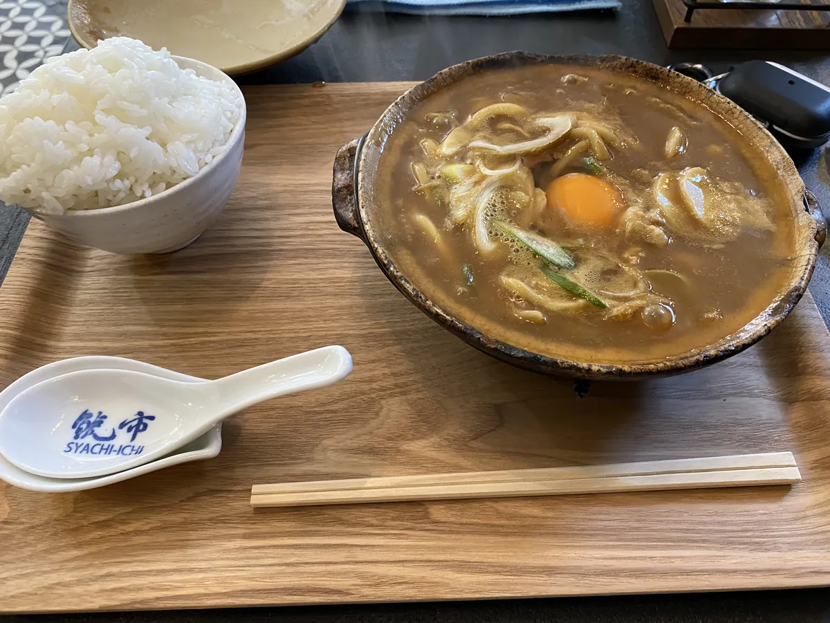 Miso nikomi udon in a clay pot with raw egg at a Nagoya restaurant
