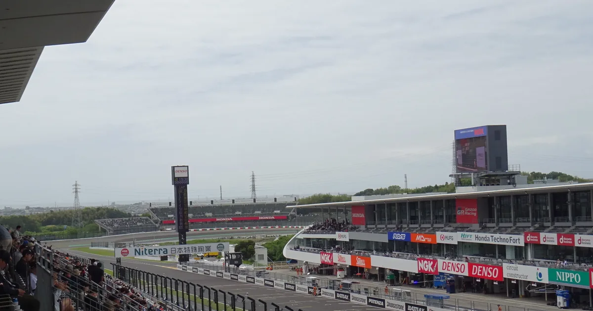 View from a grandstand over the pit lane and main straight of Suzuka Circuit on an overcast day