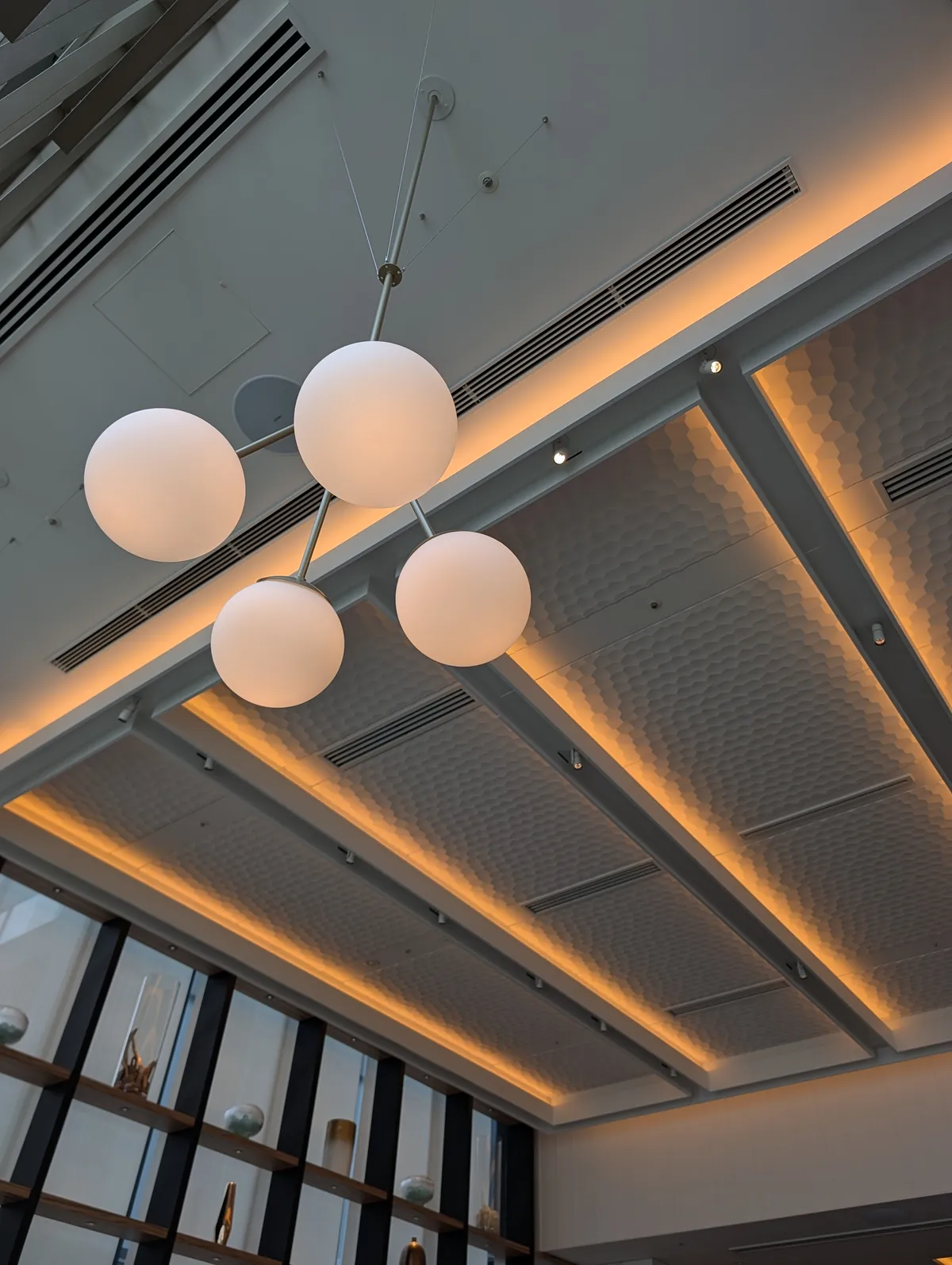 Spherical pendant lights hanging from the ceiling of the lobby at Courtyard by Marriott Nagoya, seen from below