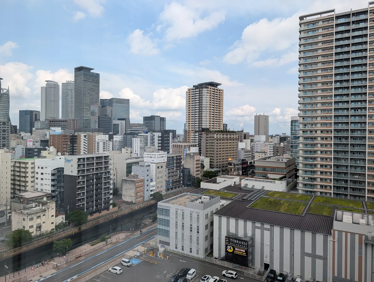 The view straight out from the room at Courtyard by Marriott Nagoya on an overcast day, dominated by a tall residential tower block across the street